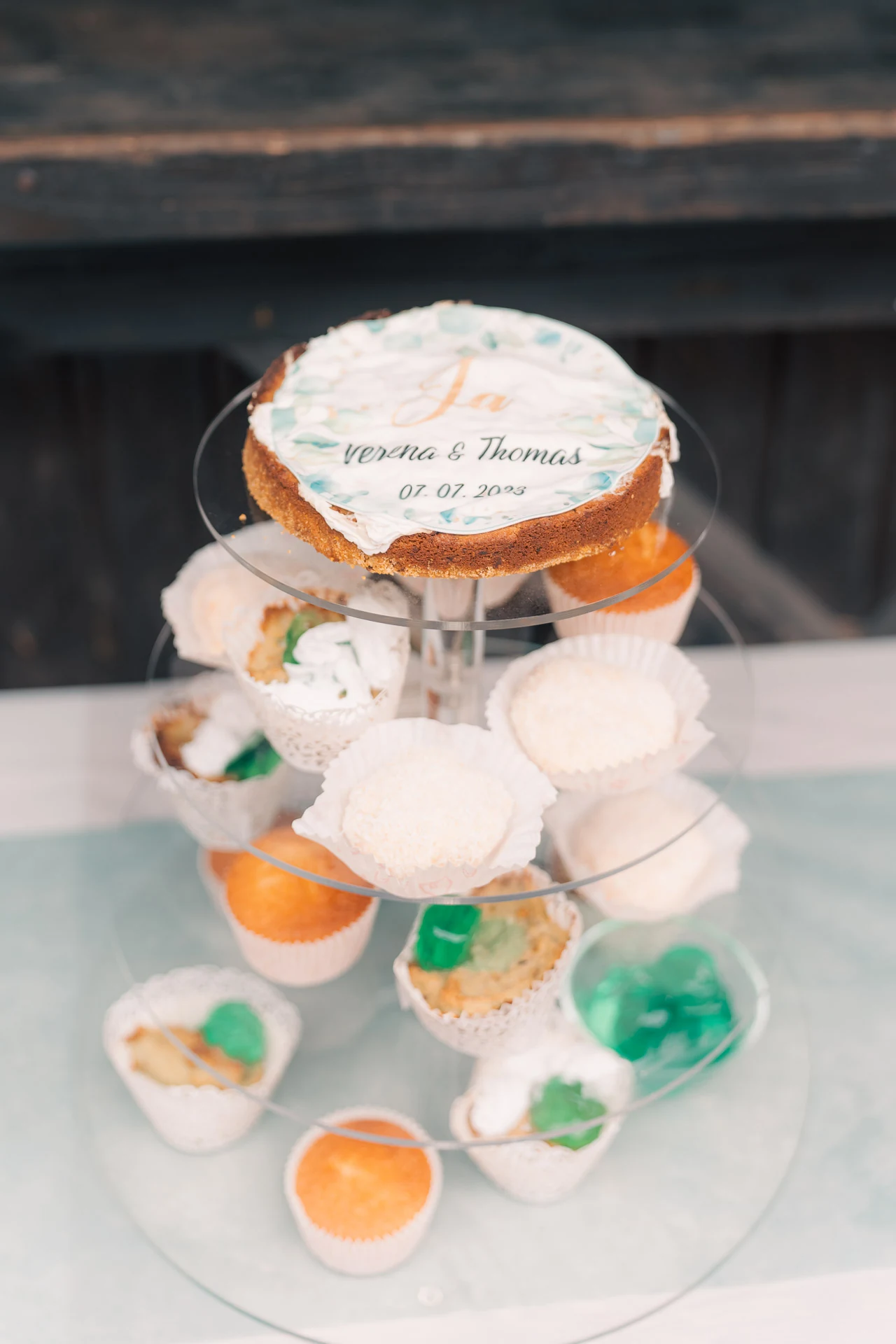 Etagere mit Cupcakes und einem Kuchen mit der Aufschrift „Verena & Thomas“